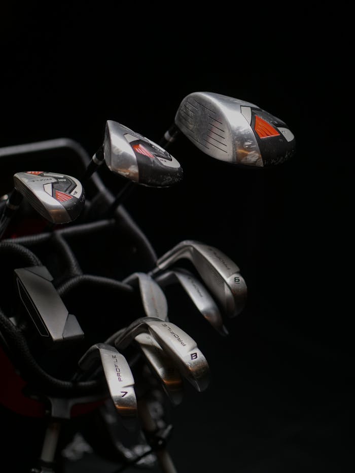 Detailed view of a set of golf clubs with a sleek design and metallic finish.